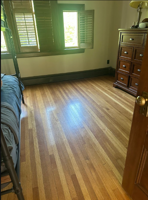 AFTER: Same bedroom after cleaning with a spotless, gleaming hardwood floor, neatly made bunkbed, and closed dresser drawers